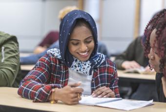 Hijab woman filling out paperwork