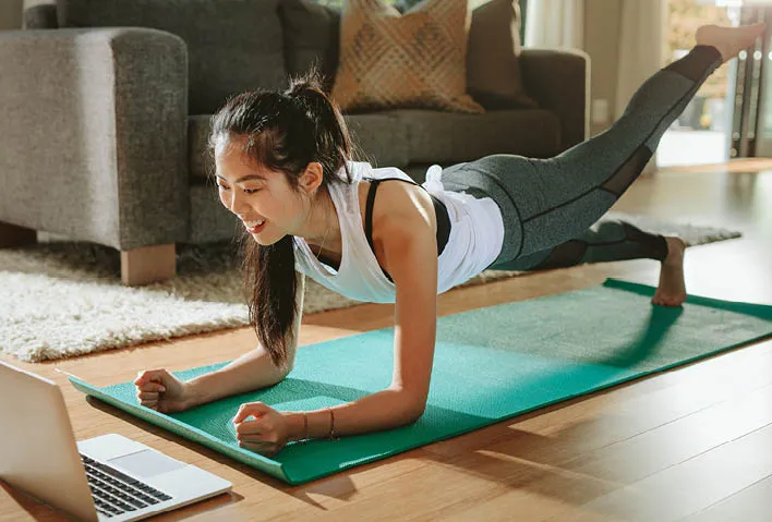 Women taking fitness class at home